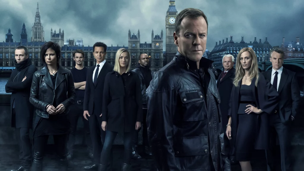 Ein Ensemble-Cast von neun Personen in dunkler Kleidung, bestehend aus fünf Männern und vier Frauen, steht auf einer Straße in London vor einer dunklen, stürmischen Kulisse. Kiefer Sutherland, in einer schwarzen Lederjacke, steht prominent im Vordergrund und blickt direkt in die Kamera. Hinter ihm ist der Big Ben und das Palace of Westminster zu sehen. Die Gesamtstimmung ist ernst und düster, passend zu einem Action-Thriller.
